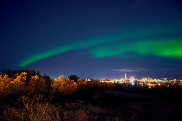 northern lights above reykjavik in iceland at night