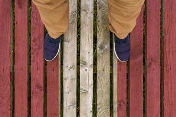 man stepped on a flag of Peru painted on a wooden floor