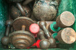 Old rusty weights in a green metal box 1