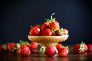 Poster - ripe red organic strawberry on a wooden table