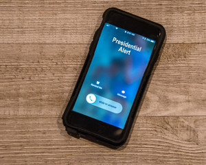 cell phone showing in coming call from the presidential alert system