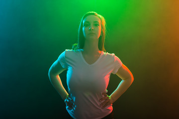 Modern dance, jazz funk and people concept - Close up portrait of dancer woman with hands on waist on colored background