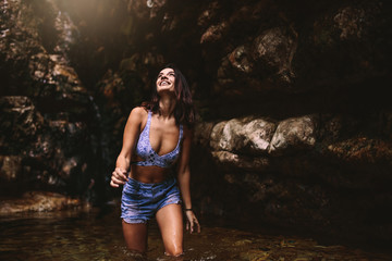 Wall Mural - Beautiful tourust girl enjoying in the rainforest pond