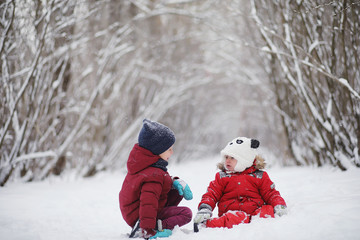 Young family with children are walking in the winter park. Winte