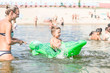 © Evgenia - Smiling mother and little baby boy are playing with a toy crocodile in the lake