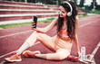 © bobex73 - Resting after training. Young woman doing fitness outdoors. Sport, fitness, recreation concept
