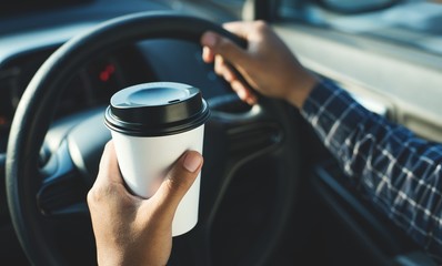 Close up male hand holding coffee paper cup.