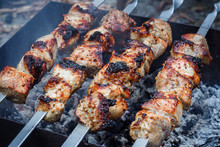 Barbecue On The Grill. Shashlik Made Of Cubes Of Meat On The Skewers During Of Cooking On The Mangal Over Charcoal