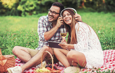 Wall Mural - Couple enjoying picnic together. Love and tenderness, dating, romance, lifestyle concept