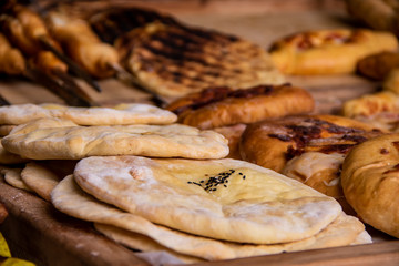 Baked flat bread lavash with spices and various fudges in the background