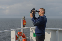 Seaman With Sextant On Navigational Bridge