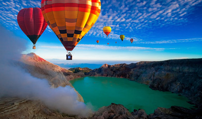 Colorful hot air balloons flying over crater Kawah Ijen at Bondowoso, Indonesia