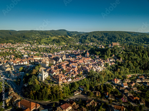 Fotografia, Obraz Aerial panorama of medieval Sighisoara in Romania with blue sky, red roofs, bast