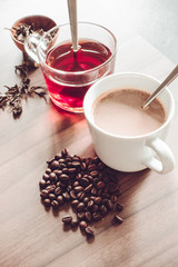 Wall Mural - Coffee and tea with coffee bean and tea leaves on wooden floor.