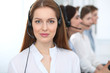 © rogerphoto - Call center. Beautiful cheerful smiling operator consulting clients with headset. Business concept of customer service