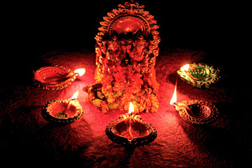 clay oil lamps and laxmi ganesha statue for diwali festival background