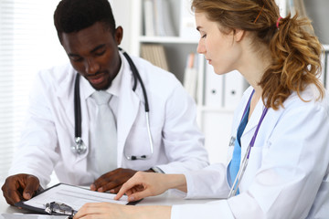 Happy african american male doctor  with medical staff at the hospital. Medicine concept