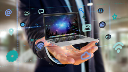 Poster - Businessman holding a Computer surrounding by app and social icon - 3d render