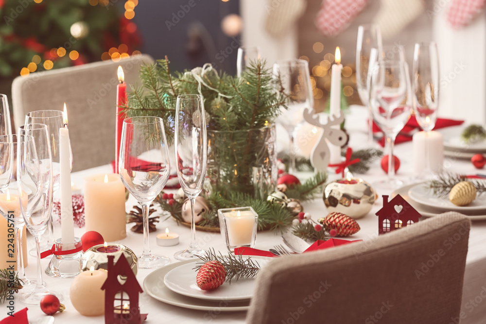 Stylish table setting with burning candles and Christmas decorations