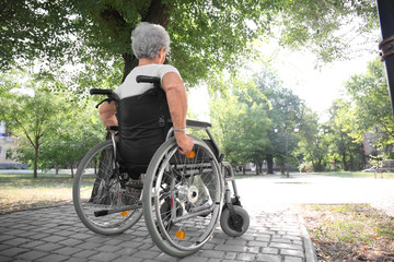 Poster - Senior woman in wheelchair outdoors