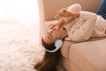 Poster - Beautiful young woman listening to music at home