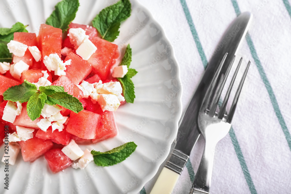 Plate with delicious watermelon salad on table, closeup