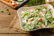 Crab sticks salad with peas, cucumber and mayonnaise.