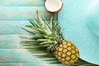 canvas print picture - Summer composition with tropical fruits and beach hat on wooden background
