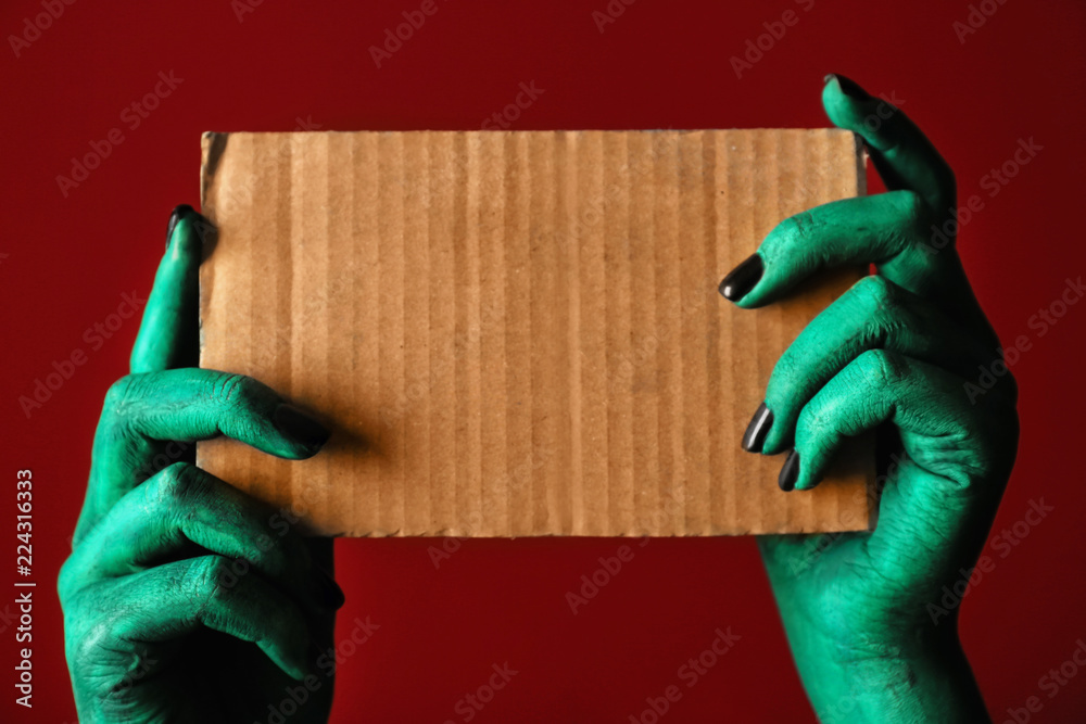 Monster holding blank card on color background