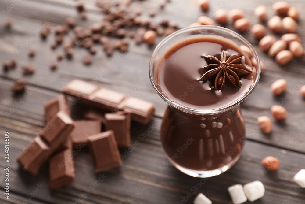 Glass of hot chocolate on wooden table