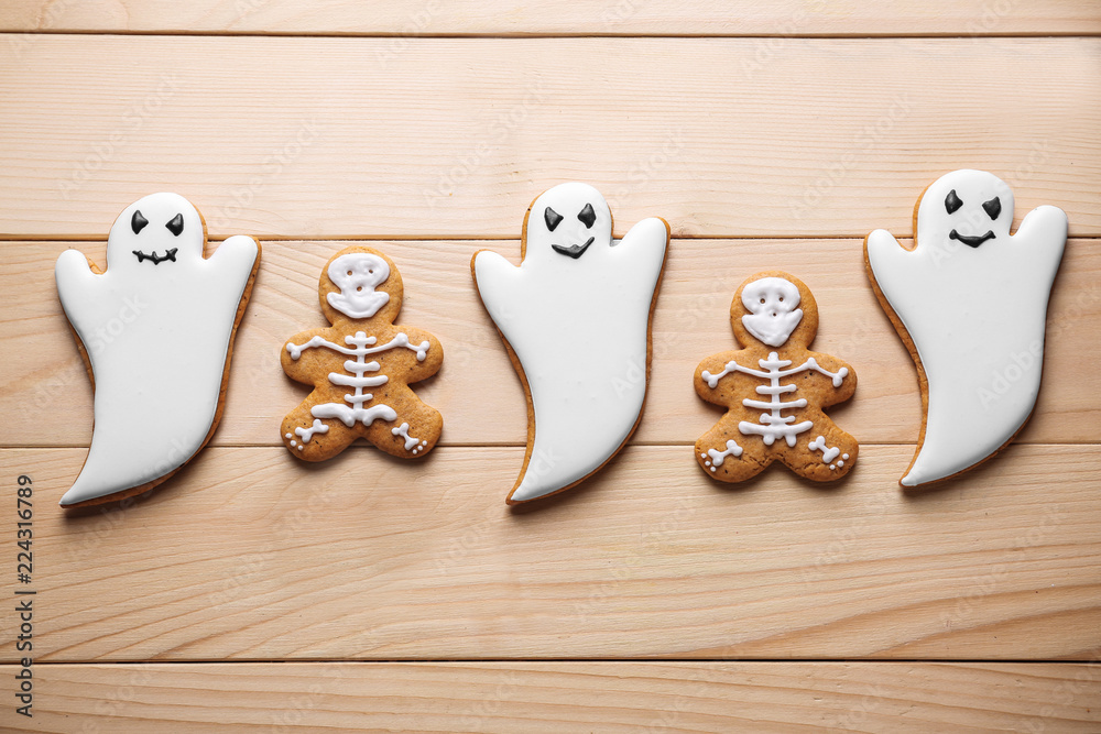 Creative cookies prepared for Halloween party on wooden background