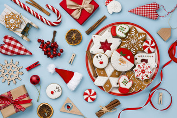 Attractive christmas gingerbread and decoration toys isolated on blue background