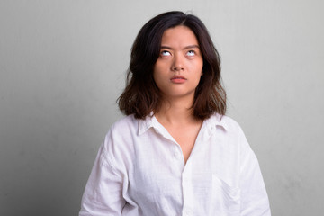 Portrait of young beautiful Asian woman with short hair