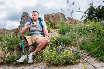 Wall Mural - Full length of a delighted male tourist resting outdoors