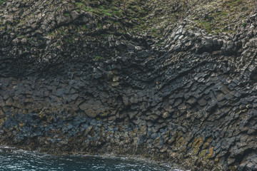 Wall Mural - full frame shot of dark rocky texture with green moss