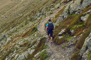 Hiker with backpack in the mountains