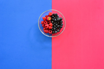 Poster - Blueberry and raspberry bowl on colorful background