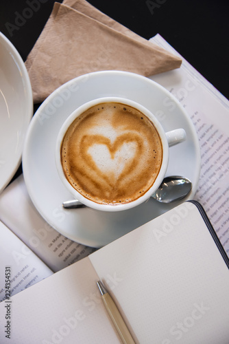 Fotografie, Obraz Magazine with latte art cappuccino. Top view shot.