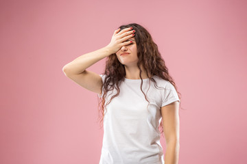 Why is that. Beautiful female half-length portrait isolated on trendy pink studio backgroud. Young emotional frustrated and bewildered woman. Human emotions, facial expression concept.