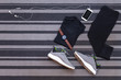 Top view of running shoes, womens clothes, pants tights, smartphone run application isolated on grey carpet.