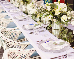 Set table for a white and aqua blue wedding dinner decorated