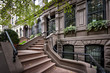 a row of colorful brownstone buildings in an iconic neighborhood  of Manhattan New York