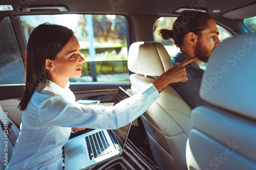 Cuadros en Lienzo Chauffeur driven limousine with the business woman in the back seat