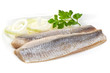 Fillet of salted marinated Atlantic herring with onion and parsley, isolated on white background.