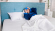 © Kyrylo Ryzhov - Portrait of sick woman with migraine lying in bed and putting wet towel on forehead