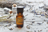 Fototapeta  - lavender essential oil with lavender on wooden background