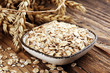 Oatmeal and oatmeal on the wooden background. Healthy eating concept