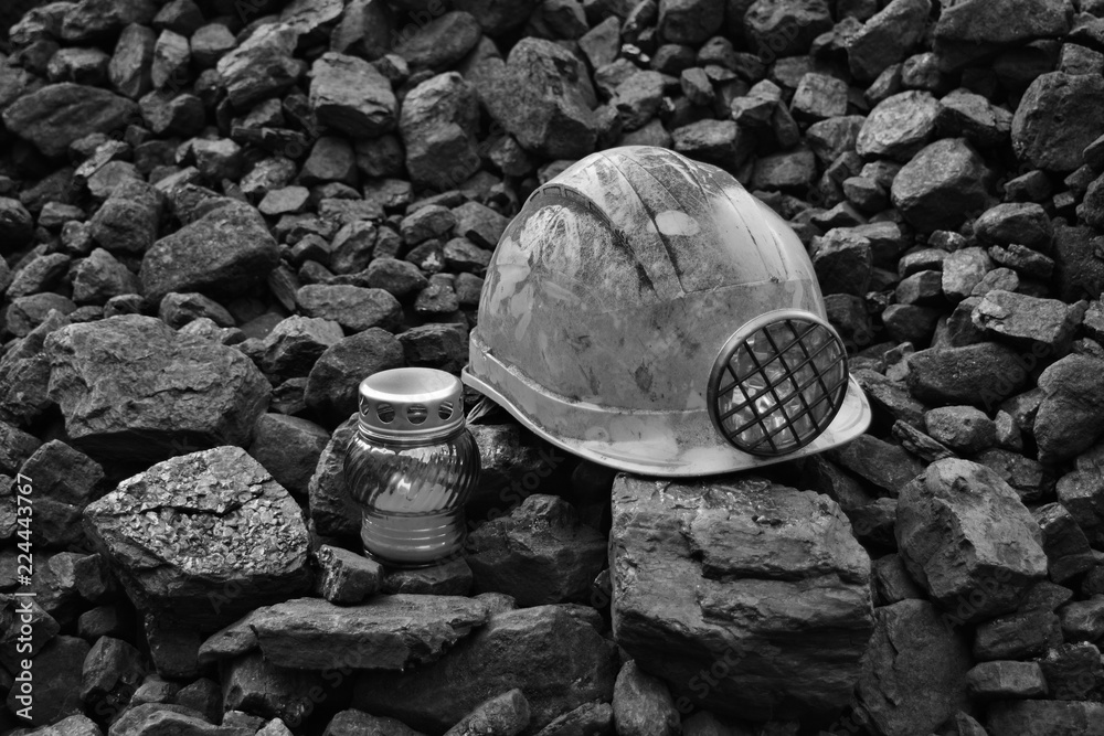 Vigil light, candle with mining helmet on cheap of coal - obrazy, fototapety, plakaty 