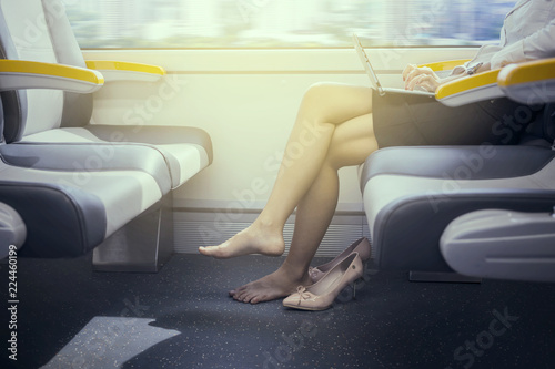 Fotografía Unknown businesswoman barefoot in airport train
