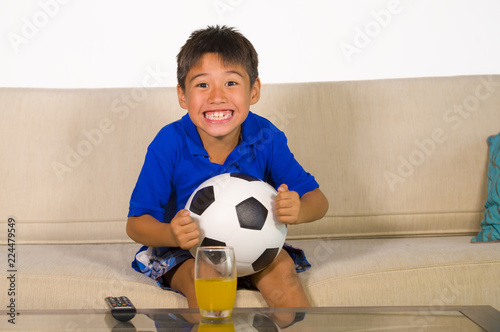 Lifestyle Portrait At Home Of Young 7 Or 8 Years Old Boy Holding